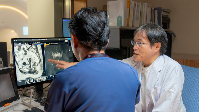 Dr. Katahira and technologist reviewing images on MR console